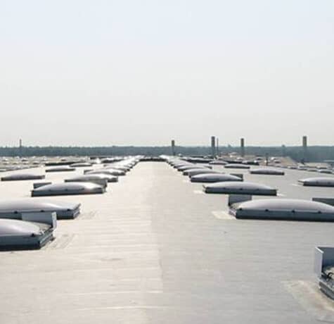 A finished GRP fibreglass flat roof with a smooth, unbroken grey topcoat and neatly formed edge trims.